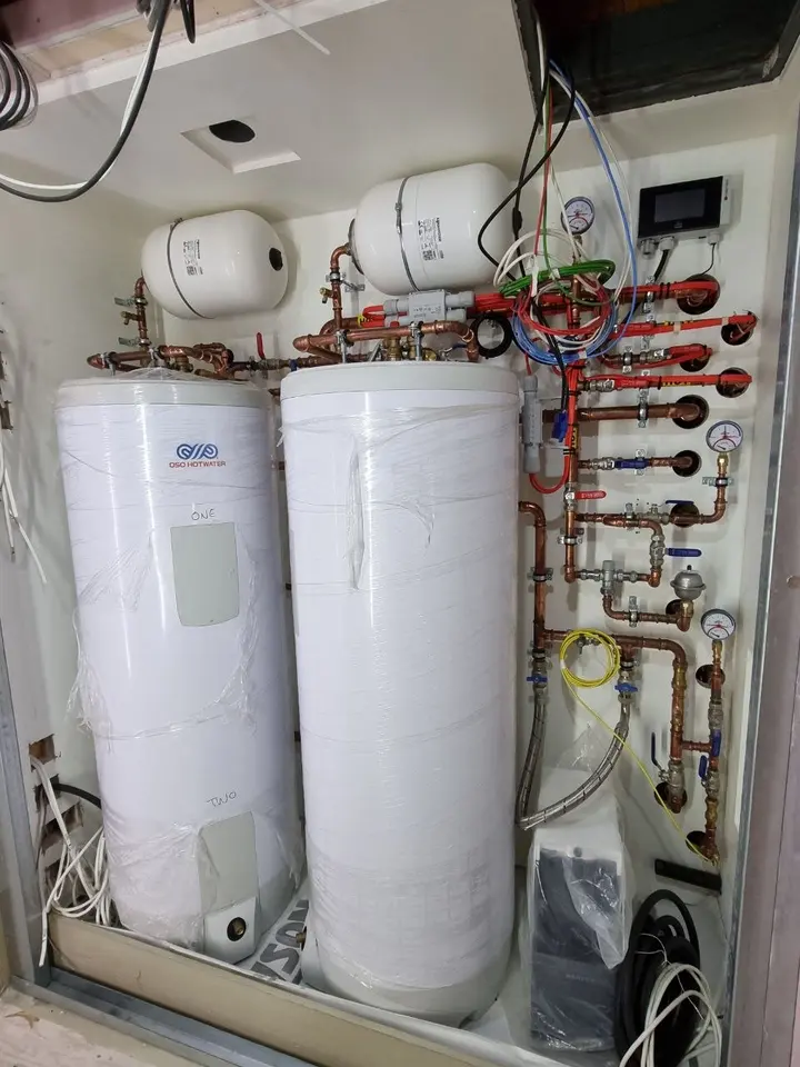 Two hot water cylinders with controls and expansion vessels